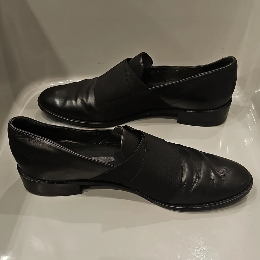 Stuart Weitzman Black Leather Slip-On Loafers